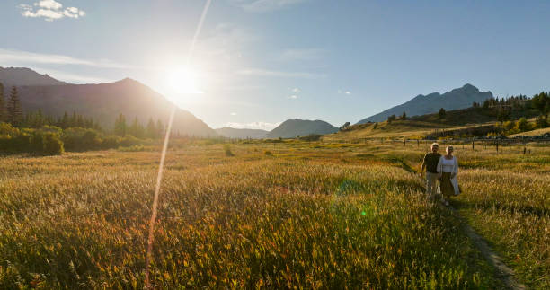 istock Mature couple hike in meadow in autumn 2184971871