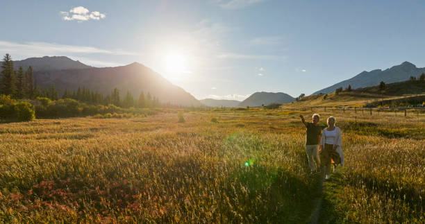 istock Mature couple hike in meadow in autumn 2184971874