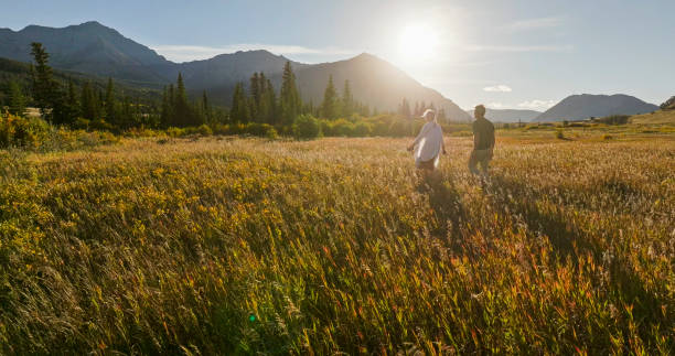 istock Mature couple hike in meadow in autumn 2184971991