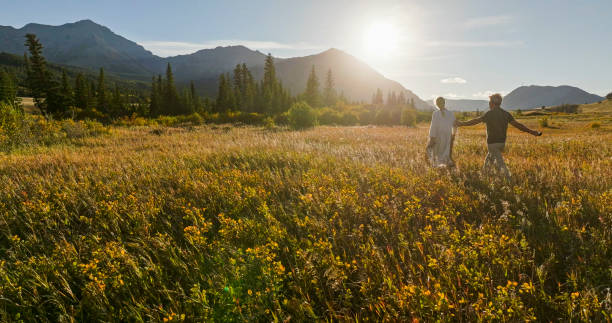 istock Mature couple hike in meadow in autumn 2184972001