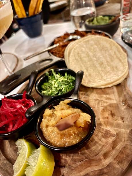 istock Pulled Pork Tacos Corn Tortilla Served With Pineapple and Habanero Jam, Pickled Red Cabbage, Coriander and Lemon Wedges at  Paladar London Restaurant Food Dinner Latin American Food Elephant and Castle Gluten Free Coeliac Celiac 2184976103