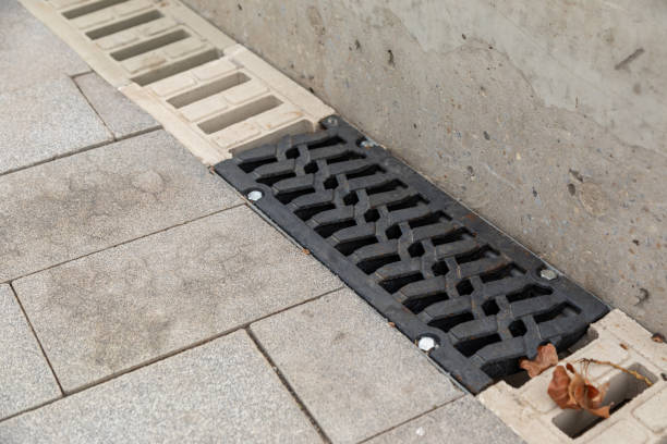 istock Contrasting black and light-colored drainage grate on stone pavement, providing functional water management and enhancing the urban landscape 2184976566