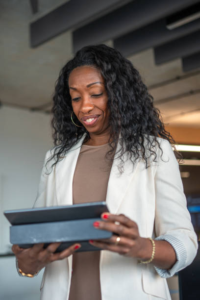 istock Black Female Professional Working on Tablet in Office Environment 2184978289
