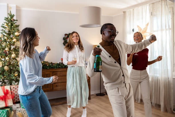 istock Joyful holiday celebration with friends dancing and enjoying champagne 2184978663