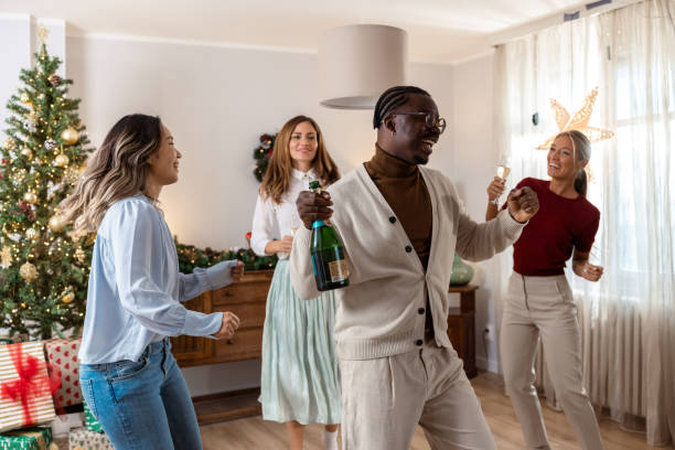 istock Joyful friends dancing at a Christmas home gathering 2184978715