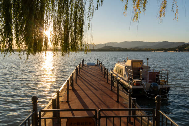 Beijing, China. 5 November 2024.  People enjoy the sunset at Kumming Lake in Yiheyuan Summer Palace, park in Beijing.