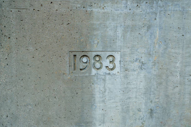 The year 1983 is carved into a concrete wall