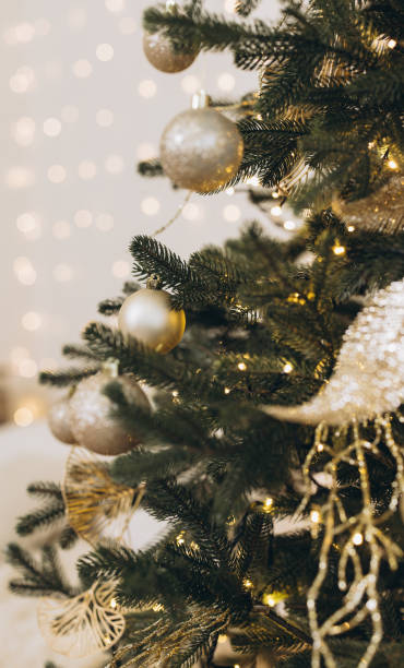 istock Christmas tree decorated with golden ornaments and lights creating festive atmosphere 2184979145