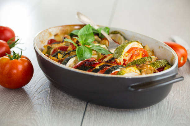 istock prepared baked zucchini and tomatoes in circles in a ceramic form, vegetable snack 2184985550