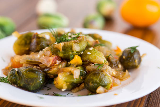 istock Brussel sprouts cooked with vegetables, on a wooden table 2184986197
