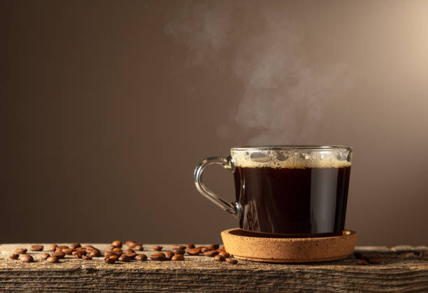 istock Black coffee in glass cup on an old wooden board. 2184987364