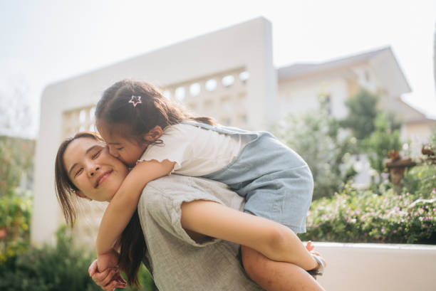 istock Mother and daughter playing together at the park. 2184989355
