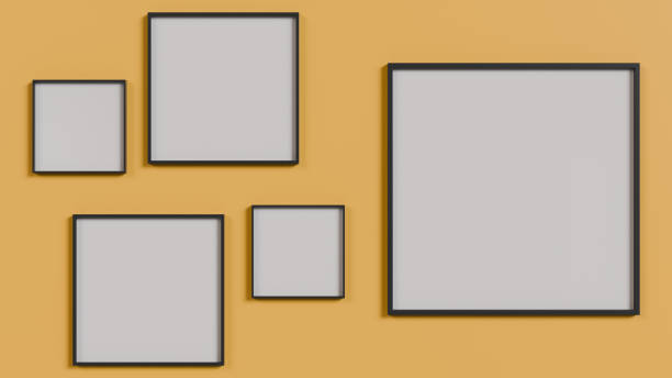 Minimalist arrangement of frames in different sizes in white on a yellow wall