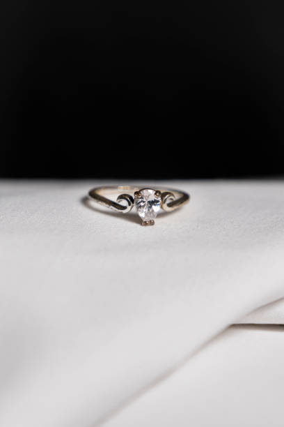 istock Photograph of a ring on a white cloth with a black background 2184990065