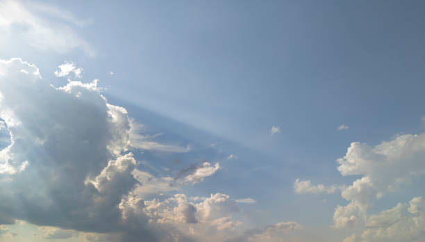 A serene sky filled with soft clouds and rays of sunlight creating a tranquil atmosphere. Perfect for backgrounds, nature themes, and peaceful imagery.