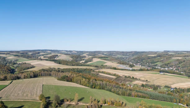 istock A panoramic view of rolling green hills under a clear blue sky, showcasing vibrant fields and distant woods, ideal for nature lovers and landscape enthusiasts. 2184996249