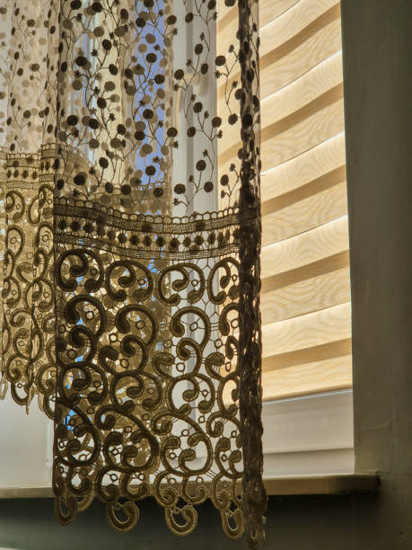 istock A beautiful view of lace curtains softly illuminated by sunlight, creating a warm and inviting atmosphere in a cozy interior. 2184996868