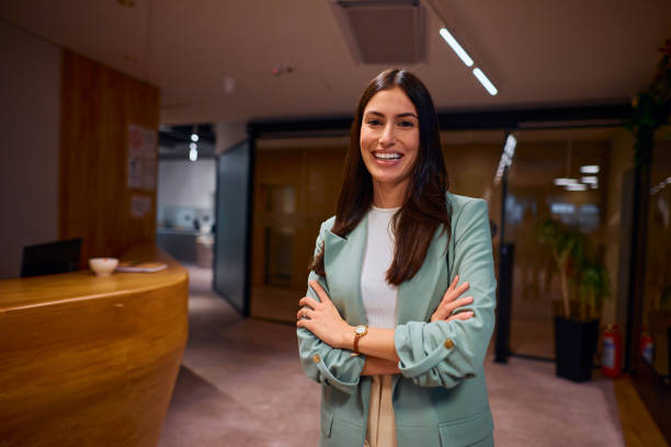istock Confident Businesswoman Smiling in Modern Office Setting 2184997471