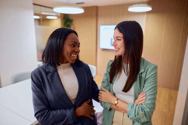 istock Two Professional Women Smiling in Modern Office Setting 2184997506