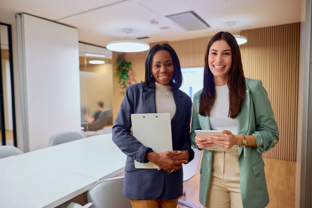istock Two Professional Women Smiling in Modern Office Setting 2184997507