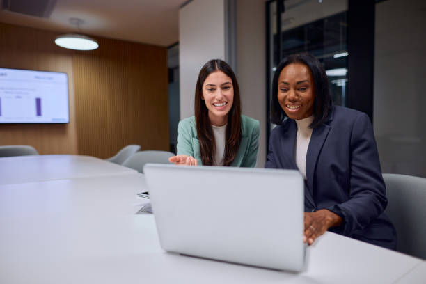 istock Two Women Collaborating on a Laptop in a Modern Office 2184997549