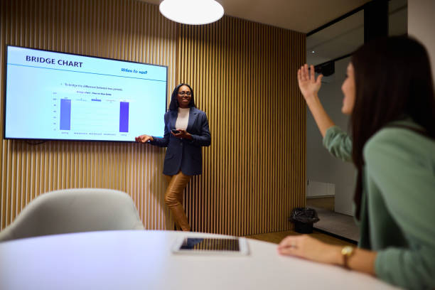 istock Woman Engaging with Speaker During Corporate Presentation in Office 2184997751