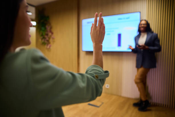 istock Woman Engaging with Speaker During Corporate Presentation in Office 2184997754