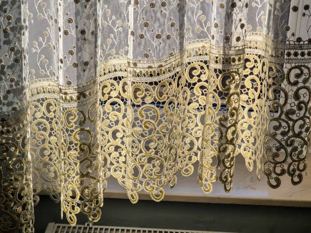istock Delicate lace curtains with intricate patterns gently draping the window, letting in soft light, adding elegance and texture to any room 2184999589