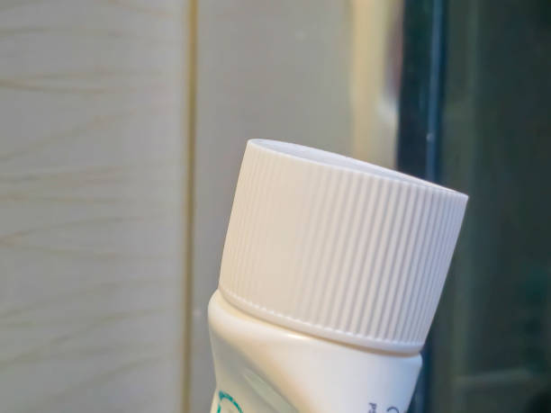 istock Close-up of a white cosmetic container against a bathroom background, emphasizing its elegant design and texture. 2184999806
