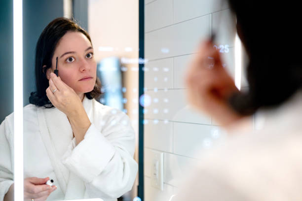 istock woman doing her morning beauty routine in front of the smart mirror 2185000064
