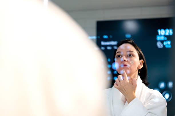 istock woman doing her morning beauty routine in front of the smart mirror 2185000066