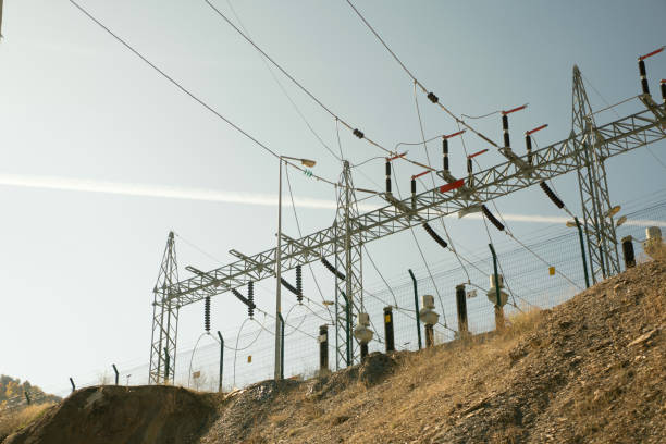 Power lines and electrical substation distributing electricity on a sunny day