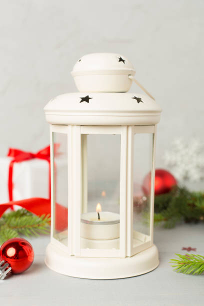 Beige christmas lantern with decorations on concrete background