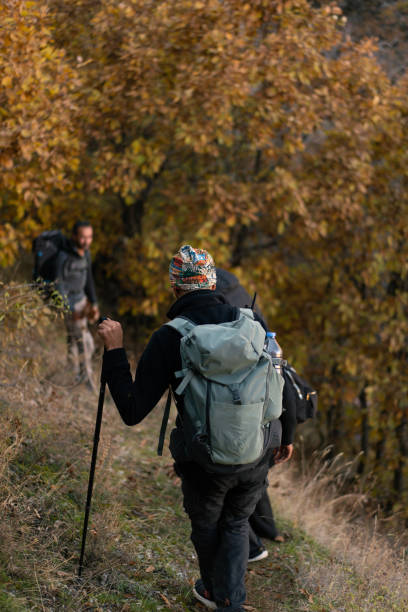 istock Hikers walking on a trail in autumn forest 2185004761