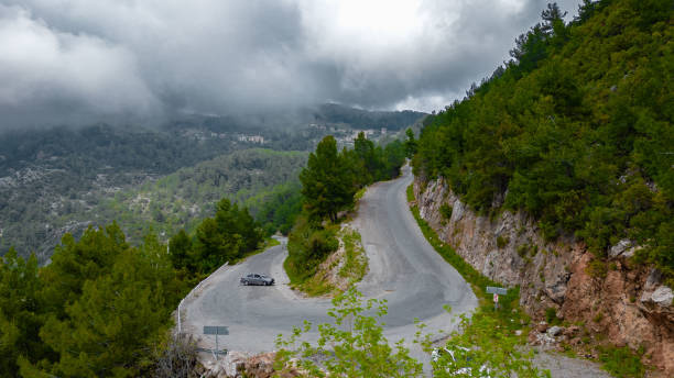istock Curved asphalt Road on the mountain with winter sky 2185005058