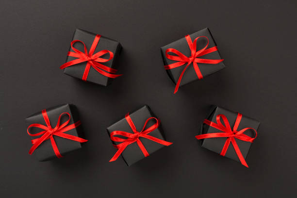 istock Black gift boxes on color background, top view. Black Friday concept 2185006771