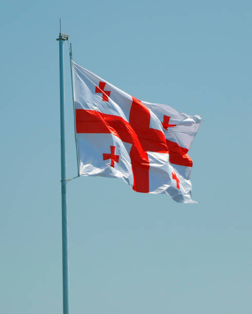istock georgian flag waving in the sky with blue background 2185008504