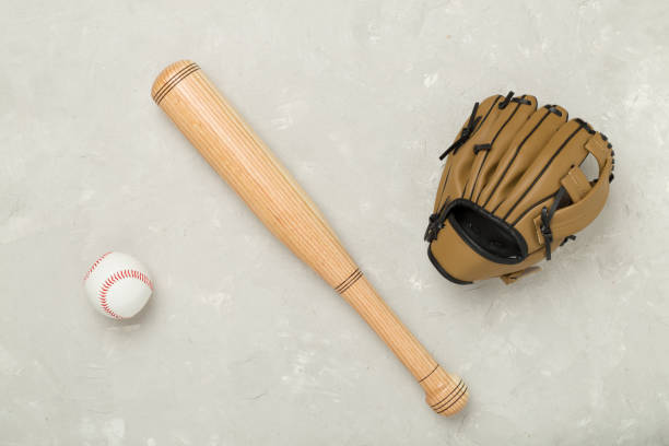 istock Baseball glove and bat with ball on concrete background, top view 2185008512