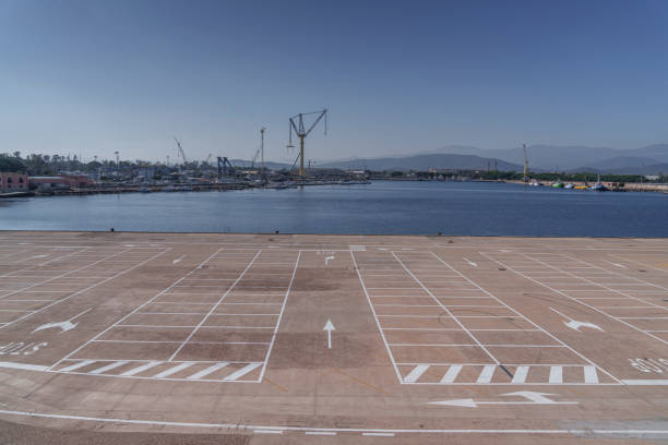 A huge empty, concrete, car park by the seaside.