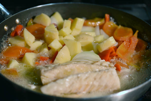 preparation of bacalhoada Portuguese cod food onion peppers olive oil salted fish