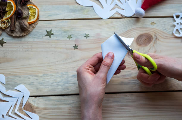 istock A snowflake made from paper with your own hands gracefully decorates a winter interior, adding warmth and a cozy atmosphere 2185010085