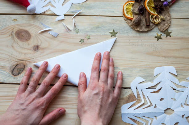 istock A snowflake made from paper with your own hands gracefully decorates a winter interior, adding warmth and a cozy atmosphere 2185010099