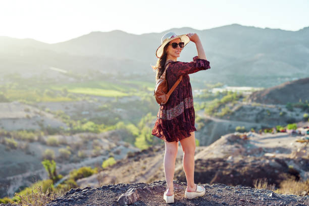 istock rear view standing latin woman looking over shoulder outdoors with a valley in the background 2185010231
