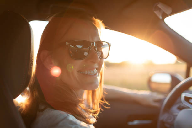 istock Happy woman driver sitting in car smiling looking at camera. 2185010347