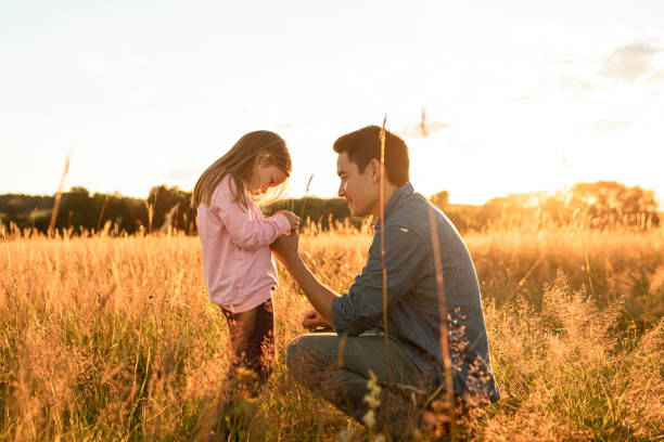 Father and daughter spring time together in the nature.
