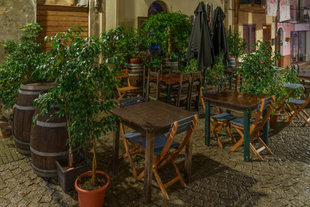 A very atmospheric, closed restaurant garden illuminated at night