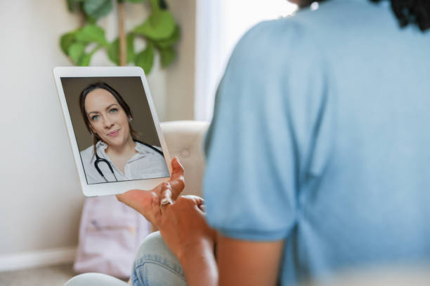 istock Young mother has telehealth appointment using digital tablet 2185012753