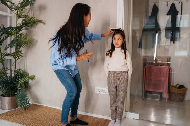 istock Tracking Growth: A Heartwarming Family Moment 2185014875