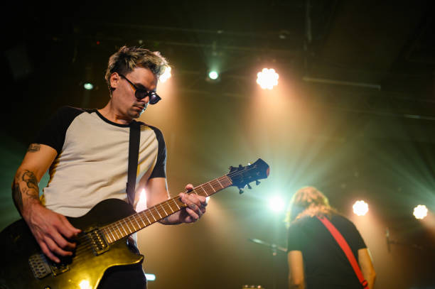 istock Guitarist playing electric guitar on stage during concert 2185015694