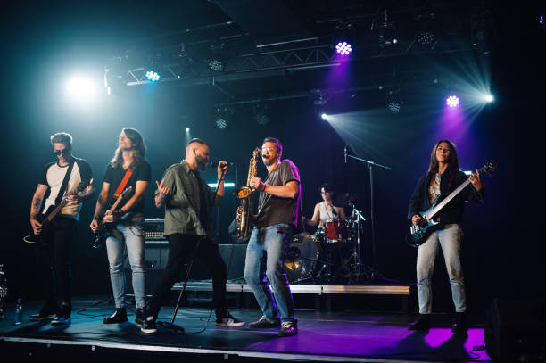istock Music band performing live on stage during a concert 2185015696